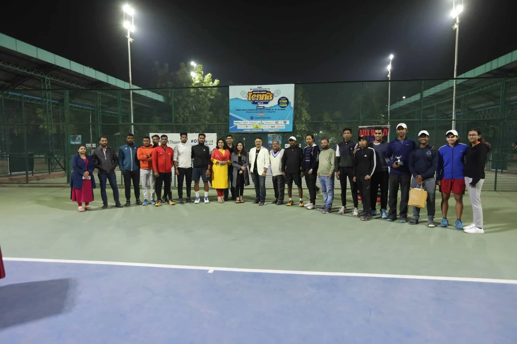 RGT players and community gathered on court under floodlights