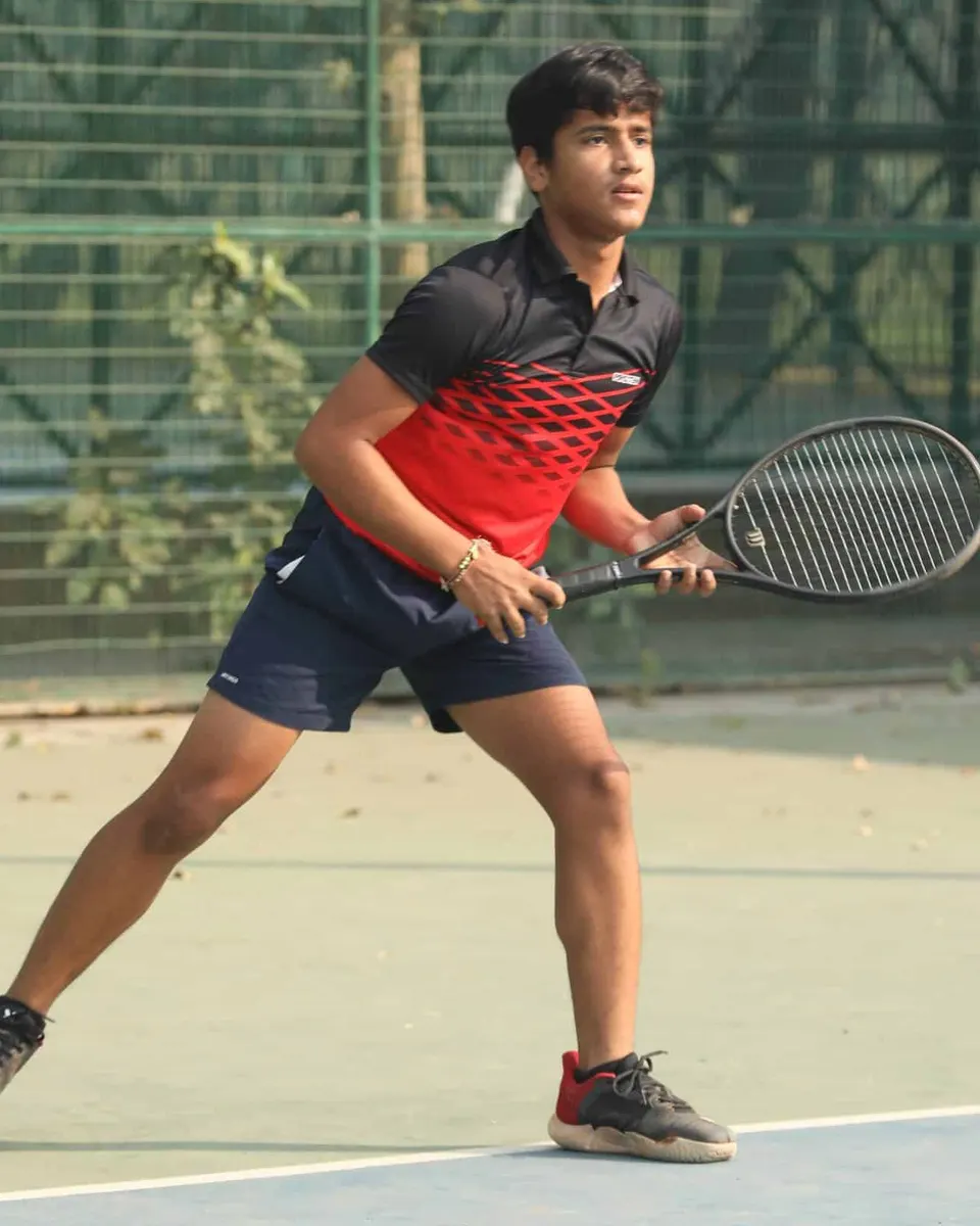 A young player steps into a forehand