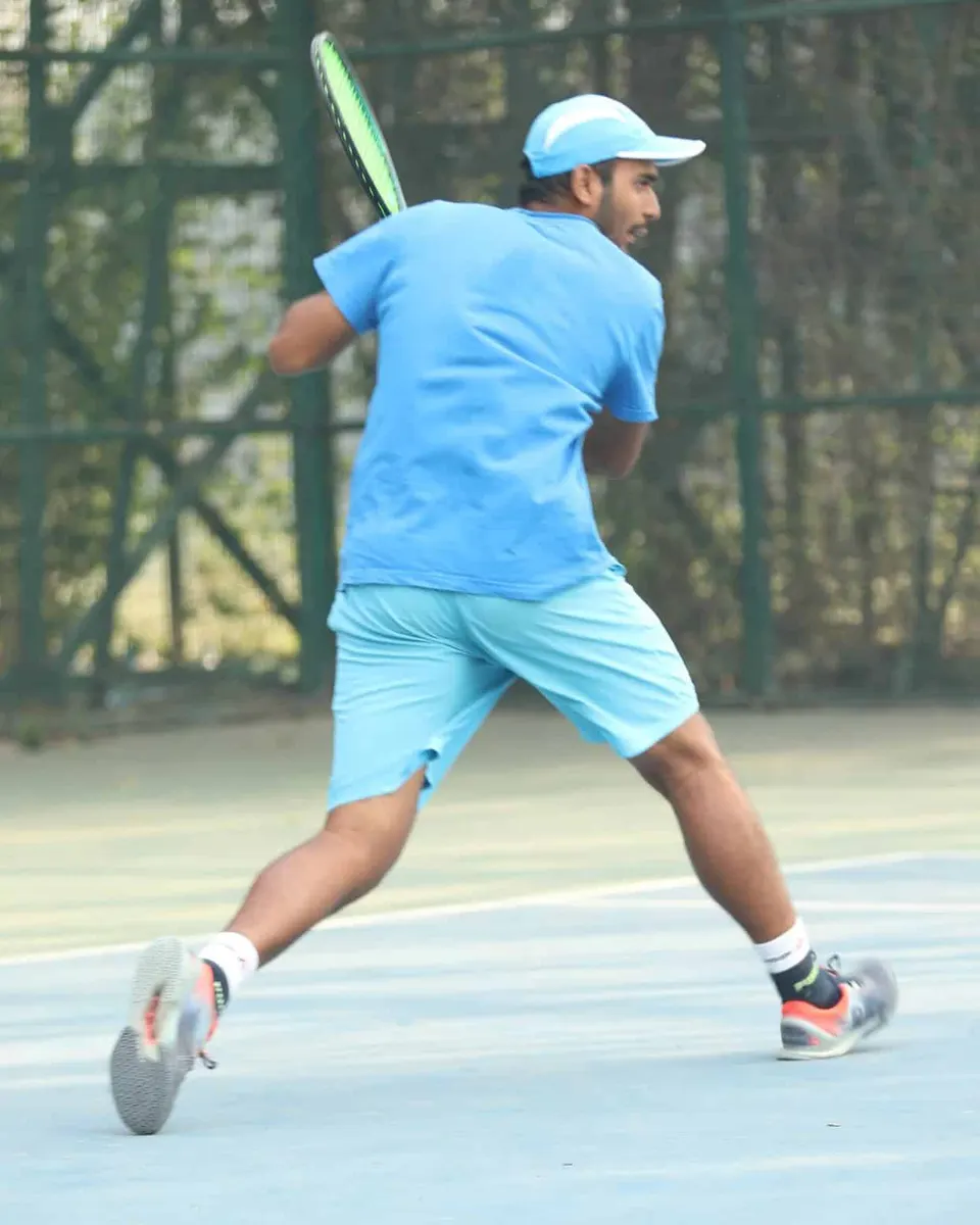 A player in blue sprints for a wide ball